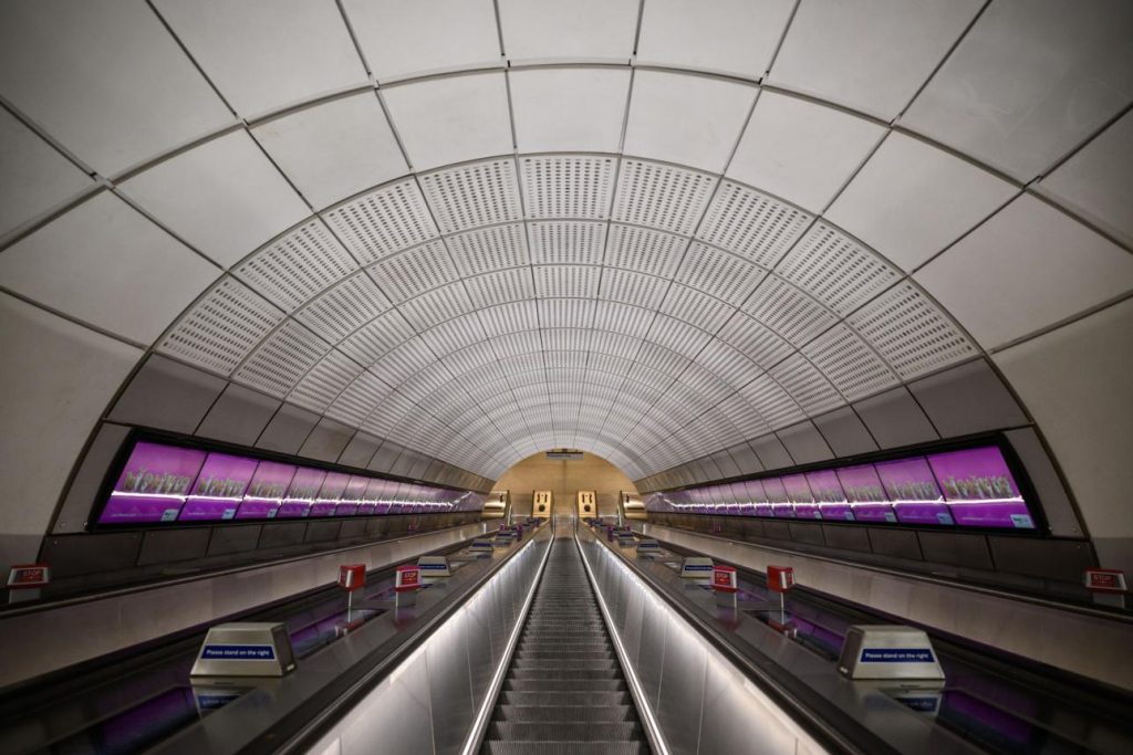 Elizabeth Line train at a London station platform with purple signage
