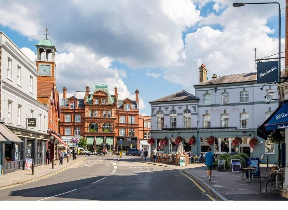 Wimbledon Village High Street with shops cafés and people walking in south west London